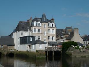 a group of buildings next to a body of water at Moulin du Tourous - Chambre 1 in Plouédern