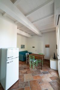 a kitchen and dining room with a refrigerator and a table at Il Timo in Marciana