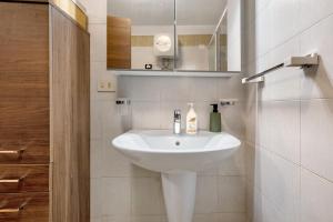 a bathroom with a white sink and a mirror at Antico Casolare di Alice in Cares +20 photos