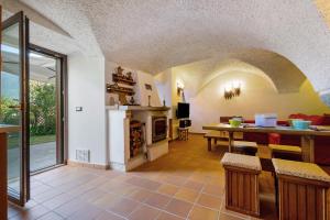 a kitchen and living room with a table and a room at Antico Casolare di Alice in Cares