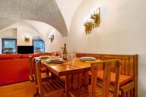 a dining room with a table and a couch at Antico Casolare di Alice in Cares