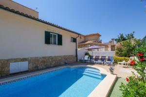 a swimming pool in the backyard of a house at Villa Loli in Alcudia