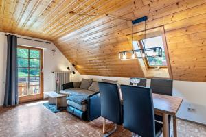 a living room with a couch and a table at Ferienhaus Gießler in Nordrach