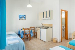 a small room with a kitchen and a table at Studios Ninemia Serifos 3 in Livadi