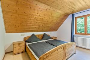 a bed in a room with a wooden ceiling at Ferienhaus Gießler in Nordrach