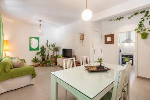 a living room with a white table and a couch at Boutique Beach Mataró in Mataró +13 photos