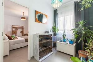 a living room with a bed and a mirror at Boutique Beach Mataró in Mataró