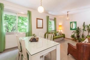 a kitchen and living room with a table and chairs at Boutique Beach Mataró in Mataró