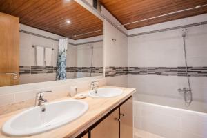 a bathroom with two sinks and a shower at Villa Can Serra in Port de Pollensa +18 photos
