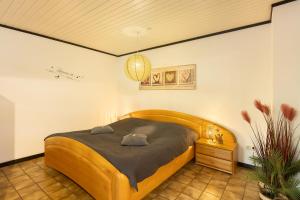 a bedroom with a large wooden bed in a room at Ferienwohnung Stork in Möhnesee