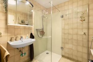 a bathroom with a sink and a shower at Ferienwohnung Stork in Möhnesee +17 photos