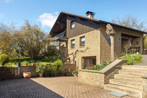 a large brick house with a brick driveway at Ferienwohnung Stork in Möhnesee