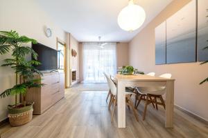 a kitchen and dining room with a table and chairs at another day in paradise in Calafell