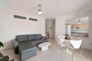 a living room with a couch and a table at Ático Bellavista B - Alcalá in Guía de Isora