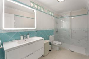 a bathroom with a sink and a toilet and a shower at Ático Bellavista B - Alcalá in Guía de Isora +20 photos