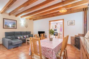 a living room with a table and a couch at Cas Pobres in Sóller