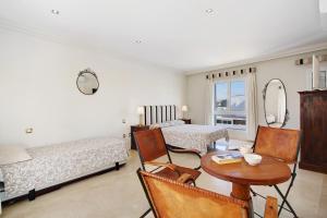 a living room with a table and a bed and a room with a mirror at Preciosa Casa En Lanzarote in Tahiche +21 photos