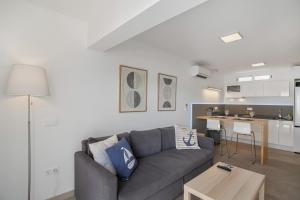 a living room with a couch and a table at Sun and serenity pool wifi in Puerto Rico de Gran Canaria