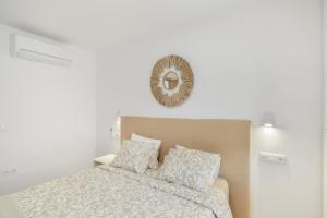 a bedroom with a bed with a mirror on the wall at Sun and serenity pool wifi in Puerto Rico de Gran Canaria +16 photos
