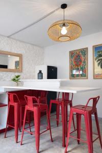 a dining room with red chairs and a white table at Therma Pilgrim Hostel in Caldas de Reis +22 photos