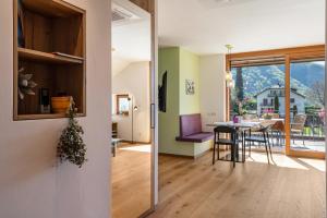 a kitchen and living room with a table and chairs at Haus Rosengarten Apt D in Terlano