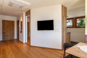 a living room with a flat screen tv on a wall at Haus Rosengarten Apt D in Terlano