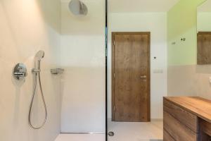 a shower with a glass door in a bathroom at Haus Rosengarten Apt D in Terlano +21 photos