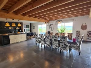 a kitchen and dining room with a table and chairs at Villa des ermites in Favières