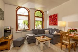 a living room with a couch and a table at Ferienwohnungen Wiese - Nickel 2 in Arnis