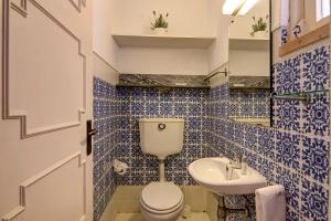 a blue tiled bathroom with a toilet and a sink at Villa Apple in Vale do Lobo +16 photos