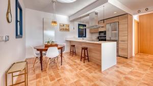 a kitchen and dining room with a table and chairs at Costacabana - Casa Adora in Tossa de Mar