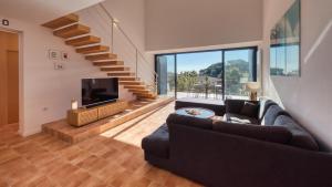 a living room with a couch and a tv at Costacabana - Casa Adora in Tossa de Mar +7 photos