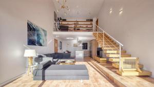 a living room with a blue couch and stairs at Costacabana - Casa Adora in Tossa de Mar