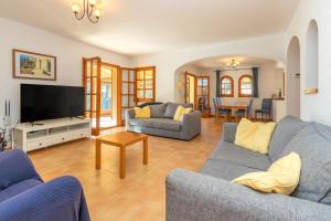a living room with two couches and a flat screen tv at Villa Rosa in Calonge