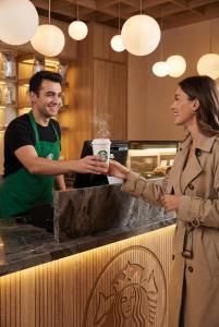a man and woman standing at a counter in a kitchen at Edition Old City Hotel in Istanbul