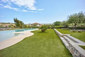 a park with a bench and a swimming pool at Appartamento Monolocale Rebi in Imperia