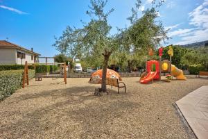 a playground with a tree and a slide at Appartamento Monolocale Rebi in Imperia