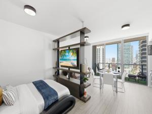 a bedroom with a bed and a tv and a table at Brickell Bay View in Miami