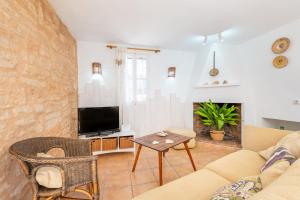 a living room with a couch and a table at Marina Ses Covetes in Campos