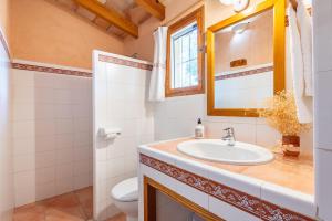 a bathroom with a sink and a toilet and a mirror at Marina Ses Covetes in Campos +21 photos