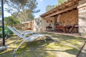 a metal chair in the yard of a house at Marina Ses Covetes in Campos