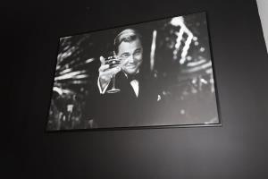 a black and white photo of a man holding a wine glass at Chalet Le Select - Private Spa with River View in Les Éboulements