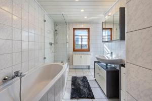 a white bathroom with a tub and a sink at Pillnitzer Schlossblick in Dresden