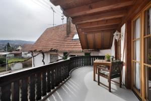 a balcony with a table and a window at Gästehaus Weingut Mangel in Endingen