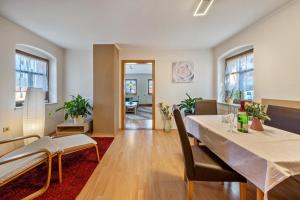 a dining room and living room with a table and chairs at Pillnitzer Schlossblick in Dresden