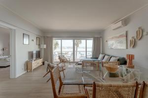 a living room with a glass table and chairs at Cascais Bay Terrace I in Cascais