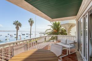 a balcony with a table and chairs and a view of the water at Cascais Bay Terrace I in Cascais