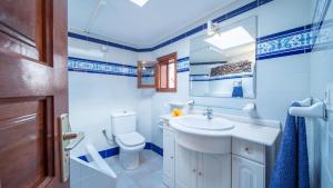 a bathroom with a white sink and a toilet at Casa Margarita 3 in Mala