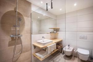 a bathroom with a sink and a shower and a toilet at Stoana Apt 2-2 in San Giacomo +19 photos