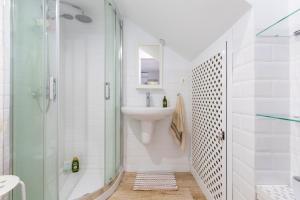 a white bathroom with a sink and a shower at Casa La Puente in Mijas +19 photos